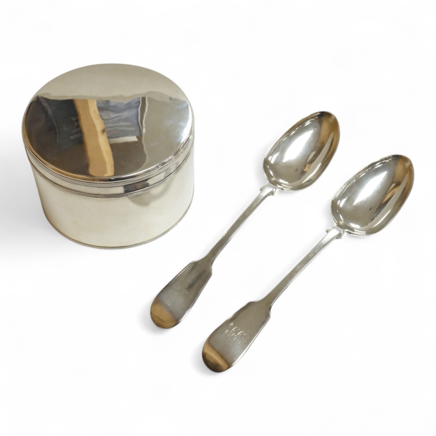 An early 19th century Dutch white metal circular biscuit box, with hinged cover and reeded bands, maker IT, retailed by Diemont, height 78mm, together with a pair of Victorian silver fiddle pattern table spoons by Willia
